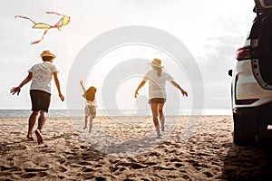 Happy Family with car travel road trip. summer vacation in car in the sunset, Dad, mom and daughter happy traveling enjoy together