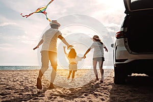 Happy Family with car travel road trip. summer vacation in car in the sunset, Dad, mom and daughter happy traveling enjoy together