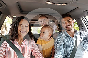 Happy family in car on trip