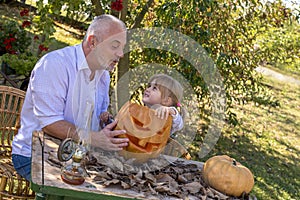 Happy family  carving pumpkin together and enjoying a day together