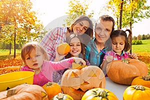 Happy family carving pumpkins prepare to Halloween