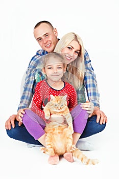 Happy family and a cat sitting in the studio.