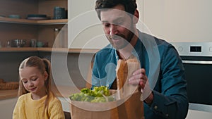 Happy family Caucasian father with kid girl unpacking shopping reusable eco bag little 10s child daughter help dad