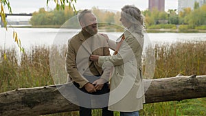 Happy family Caucasian mid age couple female male rest together autumn weekend senior man talking to mature woman two