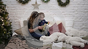 happy family of caucasian mother and child playing idoors in christmas decoration during photo shot