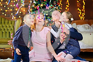 Happy family celebrates in a decorated room near the festive Christmas tree