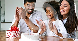 Happy family celebrating a birthday together at home