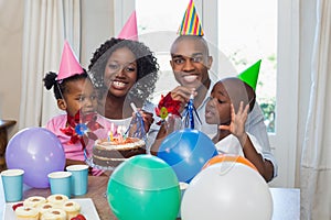 Happy family celebrating a birthday together at table