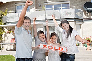 Happy family celebrating buying their new house