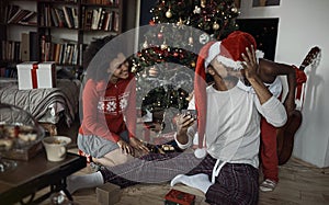 Family celebrating Christmas together. African American Family exchanging gifts