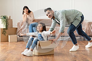 Happy family celebrating moving day in new apartment