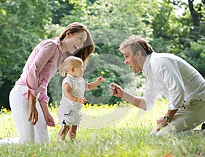 Happy family with child giving flower to father