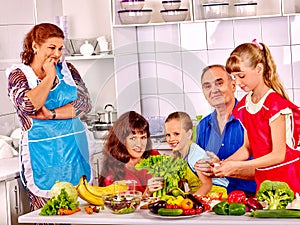 Happy family with child and grandparent cooking