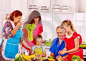 Happy family with child and grandparent cooking