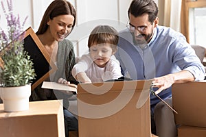 Happy family with child unpack at new home