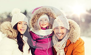 Happy family with child in winter clothes outdoors