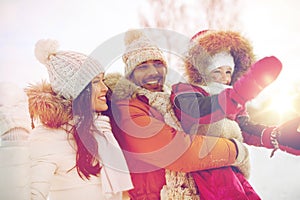 Happy family with child in winter clothes outdoors