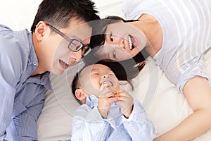 Happy family with children in bed