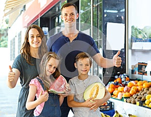 Happy family with children demostration fruits photo