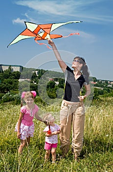 Happy family and children fly kite.