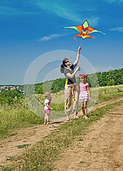 Happy family and children fly kite.