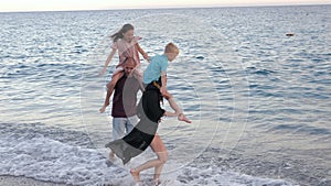 A happy family with children having fun on the beach.