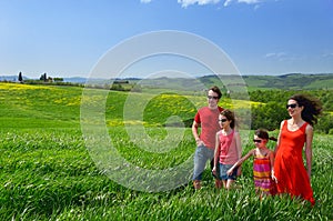 Happy family with children having fun outdoors on holiday