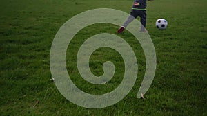 Happy Family Of Children Having Fun In Spring Park. Little Kid Run. Child Boy Dribbles Black White Classic Soccer Ball