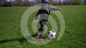 Happy Family Of Children Having Fun In Spring Park. Little Kid Run. Child Boy Dribbles Black White Classic Soccer Ball