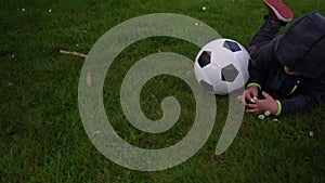 Happy Family Of Children Having Fun In Spring Park. Little Kid Run. Child Boy Lying With Black White Classic Soccer Ball