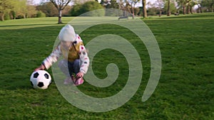 Happy Family Of Children Having Fun In Spring Park. Little Kid Run. Child Girl Dribbles Black White Classic Soccer Ball