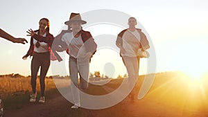 happy family children kid together run in the park fun at sunset silhouette. people in the park concept mom dad daughter