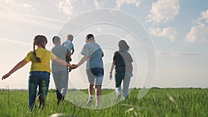 happy family. children kid together run in the park at sunset. people in the park concept. mom dad daughter and son