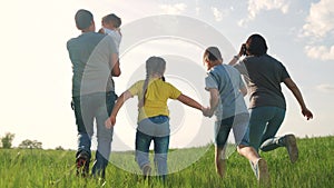 happy family. children kid together run in the park at sunset. people in the park concept. mom dad daughter and son