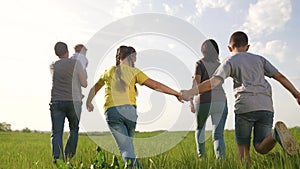happy family. children kid together run in the park at sunset. people in the park concept. mom dad daughter and son