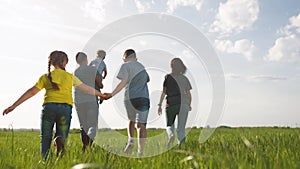 Happy family. Children kid together run in the park at sunset. People in the park concept. Mom dad daughter and son