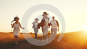 happy family children kid together run in the park at sunset silhouette. fun people in the park concept mom dad daughter