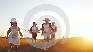 happy family children kid together run in the park at sunset silhouette. people in fun the park concept mom dad daughter