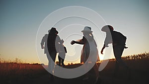 Happy family children kid together run in the park at sunset silhouette. people in the park concept mom dad daughter and