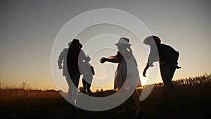 happy family children kid together run in the park at sunset silhouette. people in the park concept mom dad daughter and