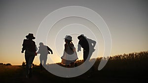 happy family children kid together run in the park at sunset silhouette. people in the park concept mom dad daughter and