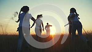 Happy family children kids together run in the park at sunset silhouette. people in the park concept mom dad daughter