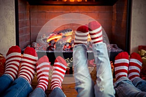 Happy family with children near fireplace at Christmas