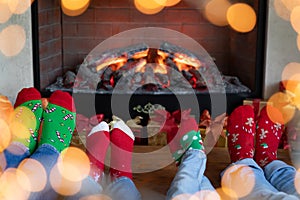 Happy family with children near fireplace at Christmas