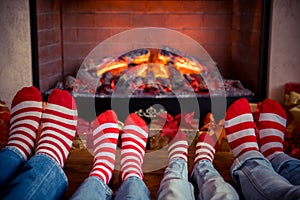 Happy family with children near fireplace at Christmas