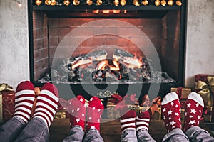 Happy family with children near fireplace at Christmas
