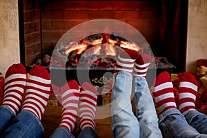 Happy family with children near fireplace at Christmas