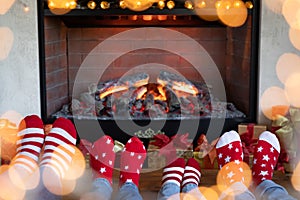 Happy family with children near fireplace at Christmas