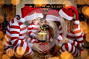 Happy family with children opening Christmas gift