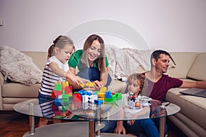 Happy family. children and parent playing with blocks toys